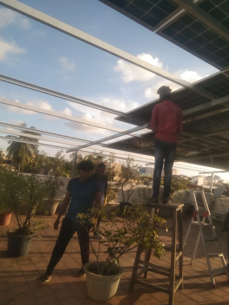 Technicians completing a solar rooftop installation